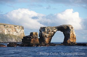 Darwins Arch, a dramatic 50-foot tall natural lava arch, rises above the ocean a short distance offshore of Darwin Island