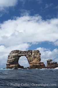 Darwins Arch, a dramatic 50-foot tall natural lava arch, rises above the ocean a short distance offshore of Darwin Island