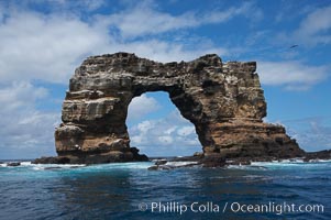 Darwins Arch, a dramatic 50-foot tall natural lava arch, rises above the ocean a short distance offshore of Darwin Island