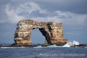 Darwins Arch, a dramatic 50-foot tall natural lava arch, rises above the ocean a short distance offshore of Darwin Island