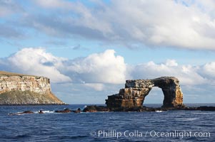 Darwins Arch, a dramatic 50-foot tall natural lava arch, rises above the ocean a short distance offshore of Darwin Island