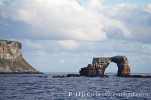 Darwins Arch, a dramatic 50-foot tall natural lava arch, rises above the ocean a short distance offshore of Darwin Island