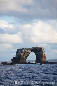 Darwins Arch, a dramatic 50-foot tall natural lava arch, rises above the ocean a short distance offshore of Darwin Island