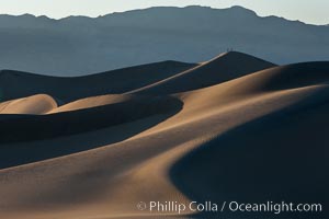 Tiny hikers atop Sand Dunes in Death Valley National Park, California.  Near Stovepipe Wells lies a region of sand dunes, some of them hundreds of feet tall.