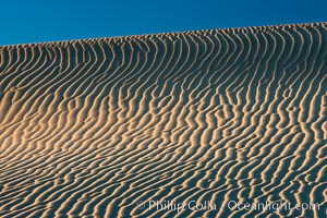 Ripples in sand dunes at sunset, California.  Winds reshape the dunes each day.  Early morning walks among the dunes can yield a look at sidewinder and kangaroo rats tracks the nocturnal desert animals leave behind, Stovepipe Wells, Death Valley National Park