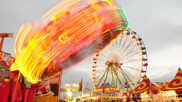 Ferris wheel and fair rides at sunset, blurring due to long exposure, Del Mar Fair