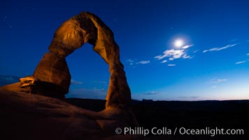 Delicate Arch and the Moon at Sunset.  The moon and clouds, with stars showing faintly in the sky, as sunset fades into night. (Note: this image was created before a ban on light-painting in Arches National Park was put into effect.  Light-painting is no longer permitted in Arches National Park)