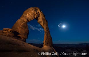 Delicate Arch and the Moon at Sunset.  The moon and clouds, with stars showing faintly in the sky, as sunset fades into night. (Note: this image was created before a ban on light-painting in Arches National Park was put into effect.  Light-painting is no longer permitted in Arches National Park)