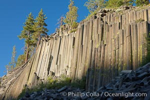 Devil's Postpile, a spectacular example of columnar basalt.  Once molten and under great pressure underground, the lava that makes up Devil's Postpile cooled evenly and slowly, contracting and fracturing into polygonal-sided columns.  The age of the formation is estimated between 100 and 700 thousand years old.  Sometime after the basalt columns formed, a glacier passed over the formation, cutting and polishing the tops of the columns.  The columns have from three to seven sides, varying because of differences in how quickly portions of the lava cooled.