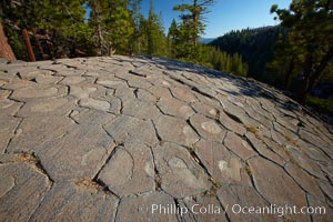 Devil's Postpile, a spectacular example of columnar basalt.  Once molten and under great pressure underground, the lava that makes up Devil's Postpile cooled evenly and slowly, contracting and fracturing into polygonal-sided columns.  The age of the formation is estimated between 100 and 700 thousand years old.  Sometime after the basalt columns formed, a glacier passed over the formation, cutting and polishing the tops of the columns.  The columns have from three to seven sides, varying because of differences in how quickly portions of the lava cooled, Devils Postpile National Monument, California