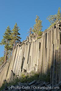 Devil's Postpile, a spectacular example of columnar basalt.  Once molten and under great pressure underground, the lava that makes up Devil's Postpile cooled evenly and slowly, contracting and fracturing into polygonal-sided columns.  The age of the formation is estimated between 100 and 700 thousand years old.  Sometime after the basalt columns formed, a glacier passed over the formation, cutting and polishing the tops of the columns.  The columns have from three to seven sides, varying because of differences in how quickly portions of the lava cooled, Devils Postpile National Monument, California