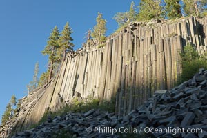 Devil's Postpile, a spectacular example of columnar basalt.  Once molten and under great pressure underground, the lava that makes up Devil's Postpile cooled evenly and slowly, contracting and fracturing into polygonal-sided columns.  The age of the formation is estimated between 100 and 700 thousand years old.  Sometime after the basalt columns formed, a glacier passed over the formation, cutting and polishing the tops of the columns.  The columns have from three to seven sides, varying because of differences in how quickly portions of the lava cooled, Devils Postpile National Monument, California