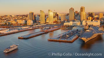 Downtown San Diego bayfront, Marina District, with the USS Midway Navy aircraft carrier (right), cruise ship terminal (left) and high rise office buildings towering over North Harbor Drive along San Diego Bay