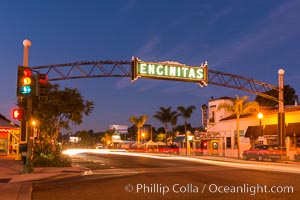 Encinitas city sign lit at night over Highway 101