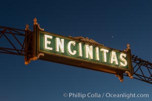 Encinitas city sign lit at night over Highway 101