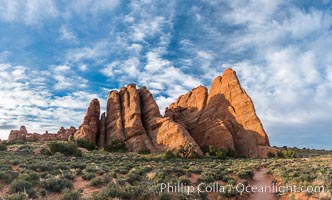 Sandstone fins stand on edge.  Vertical fractures separate standing plates of sandstone that are eroded into freestanding fins, that may one day further erode into arches.