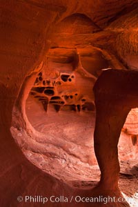 Fire Arch or Windstone Arch, also known as Fire Cave, is a tiny cave with a miniature arch and a group of natural pocket holes.  Many people walk by this cave without realizing it is there!, Valley of Fire State Park