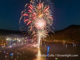 Fireworks over Bass Lake on the Fourth of July.  Each summer, boaters gather on beautiful Bass Lake to enjoy a display of Fourth of July fireworks over the lake, near Yosemite and Oakhurst in the western Sierra Nevada. Aerial photo