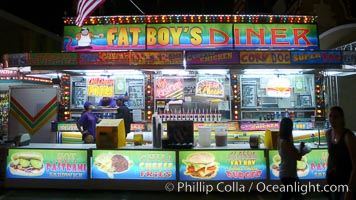 Food vendors at the Del Mar Fair, famous for their tasty, greasy, salty, fattening and generally unwholesome food, which visitors eat by the ton.  Bright lights at night. California, USA, natural history stock photograph, photo id 20879