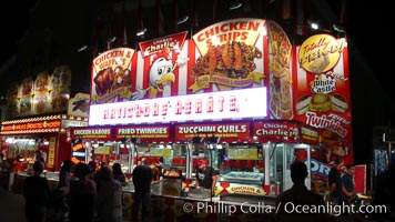 Food vendors at the Del Mar Fair, famous for their tasty, greasy, salty, fattening and generally unwholesome food, which visitors eat by the ton.  Bright lights at night