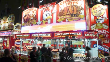 Food vendors at the Del Mar Fair, famous for their tasty, greasy, salty, fattening and generally unwholesome food, which visitors eat by the ton.  Bright lights at night