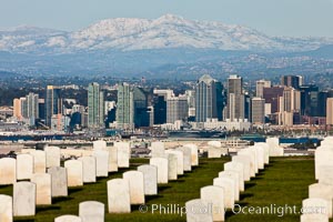 Tombstones at Fort Rosecrans National Cemetery, with downtown San Diego with snow-covered Mt. Laguna in the distance.