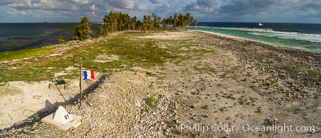 The French tricolor flag flies over Clipperton Island at sunset. Clipperton Island, a minor territory of France also known as Ile de la Passion, is a spectacular coral atoll in the eastern Pacific. By permit HC / 1485 / CAB (France)