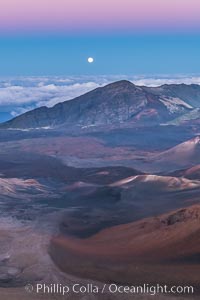 Full Moon and Earth Shadow over Haleakala crater, Maui, Hawaii.  The dark band on the horizon is the shadow of the earth, while the lighter pink band is atmosphere that is still lit by the setting sun