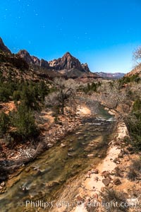 The Watchman and Virgin River under a full moon. The full moon illuminates Zion National Park at night