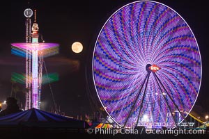 Full moon rising at night over the San Diego County Fair.  Del Mar Fair at night