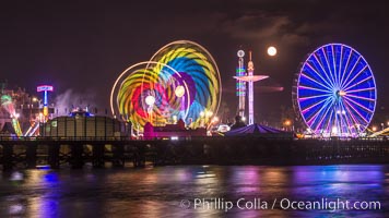 Full moon rising at night over the San Diego County Fair.  Del Mar Fair at night.