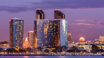 Full moon rising over San Diego city skyline, sunset, storm clouds, viewed from Coronado Island