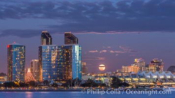 Full moon rising over San Diego city skyline, sunset, storm clouds, viewed from Coronado Island