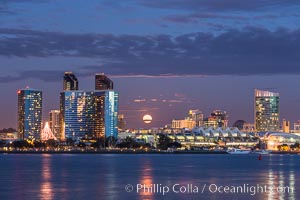 Full moon rising over San Diego city skyline, sunset, storm clouds, viewed from Coronado Island