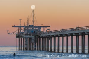 Full Moon Setting Over SIO Pier in the moments just before sunrise, Scripps Institution of Oceanography, La Jolla, California