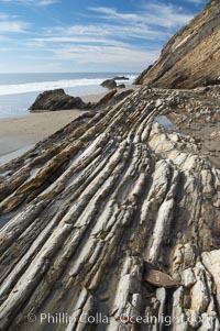 Shale is a fine-grained detrital sedimentary rock formed by the compaction of clay, silt, or mud.  Shale is formed when mud is pressed into rock over millions of years and often breaks into big flat pieces. Here layers of shale emerge from the sand and cliffs at Gaviota State Beach north of Santa Barbara