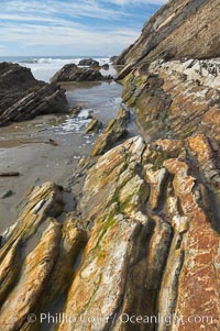 Shale is a fine-grained detrital sedimentary rock formed by the compaction of clay, silt, or mud.  Shale is formed when mud is pressed into rock over millions of years and often breaks into big flat pieces. Here layers of shale emerge from the sand and cliffs at Gaviota State Beach north of Santa Barbara