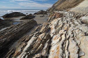 Shale is a fine-grained detrital sedimentary rock formed by the compaction of clay, silt, or mud.  Shale is formed when mud is pressed into rock over millions of years and often breaks into big flat pieces. Here layers of shale emerge from the sand and cliffs at Gaviota State Beach north of Santa Barbara