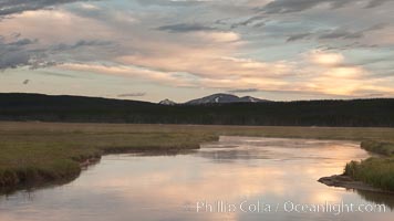 Gibbon River meanders through Gibbon Meadows, sunrise and clouds reflected in the calm waters, Wyoming.