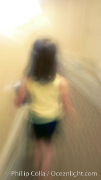 Girl walks down hotel corridor at night, carrying ice bucket, abstract blur time exposure