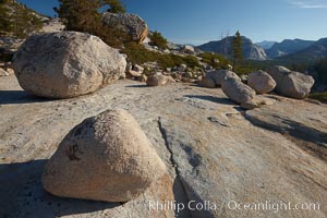 Glacial erratic boulders atop Olmsted Point. Erratics are huge boulders left behind by the passing of glaciers which carved the granite surroundings into their present-day form.  When the glaciers melt, any boulders and other geologic material that it was carrying are left in place, sometimes many miles from their original location, Yosemite National Park, California