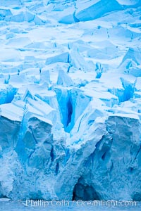 A glacier fractures and cracks, as the leading of a glacier fractures and cracks as it reaches the ocean.  The pieces will float away to become icebergs.