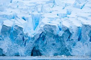 A glacier fractures and cracks, as the leading of a glacier fractures and cracks as it reaches the ocean.  The pieces will float away to become icebergs, Neko Harbor