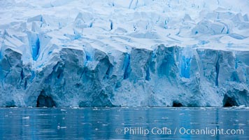 A glacier fractures and cracks, as the leading of a glacier fractures and cracks as it reaches the ocean.  The pieces will float away to become icebergs, Neko Harbor