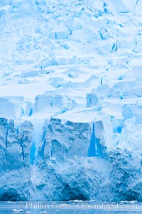 A glacier fractures and cracks, as the leading of a glacier fractures and cracks as it reaches the ocean.  The pieces will float away to become icebergs, Neko Harbor