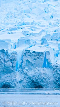 A glacier fractures and cracks, as the leading of a glacier fractures and cracks as it reaches the ocean.  The pieces will float away to become icebergs, Neko Harbor