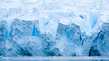 A glacier fractures and cracks, as the leading of a glacier fractures and cracks as it reaches the ocean.  The pieces will float away to become icebergs, Neko Harbor