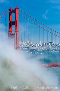 San Franciscos infamous summer fog overtakes the Golden Gate Bridge, viewed from the Marin Headlands with the city of San Francisco visible in the distance