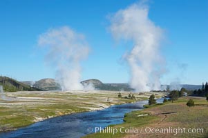 Steam rises above the Midway Geyser Basin, largely from Grand Prismatic Spring and Excelsior Geyser. The Firehole River flows by, Yellowstone National Park, Wyoming