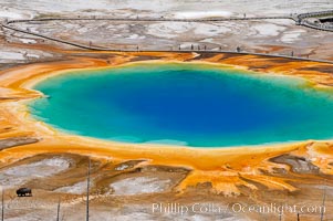 Grand Prismatic Spring displays a stunning rainbow of colors created by species of thermophilac (heat-loving) bacteria that thrive in narrow temperature ranges.  The blue water in the center is too hot to support any bacterial life, while the outer orange rings are the coolest water.  Grand Prismatic Spring is the largest spring in the United States and the third-largest in the world.  Midway Geyser Basin, Yellowstone National Park, Wyoming